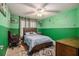 Bedroom with a bed, desk, and green and white decor at 1054 Sunny Field Ln, Lawrenceville, GA 30043