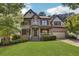 Brick two-story house with a large front yard and mature trees at 1054 Sunny Field Ln, Lawrenceville, GA 30043