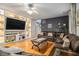 Gathering room with sectional sofa, hardwood floors and built-in shelving at 1054 Sunny Field Ln, Lawrenceville, GA 30043