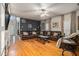 Gathering room with sectional sofa, hardwood floors and built-in shelving at 1054 Sunny Field Ln, Lawrenceville, GA 30043