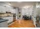 Eat-in kitchen with hardwood floors, white cabinets, and a breakfast nook at 1054 Sunny Field Ln, Lawrenceville, GA 30043