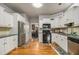 Spacious kitchen with white cabinets, stainless steel appliances, and hardwood floors at 1054 Sunny Field Ln, Lawrenceville, GA 30043