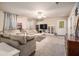 Living room with beige couches, a coffee table, and carpet flooring at 1054 Sunny Field Ln, Lawrenceville, GA 30043