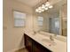 Double sink bathroom vanity with large mirror and access to other rooms at 1124 Lossie Ln, Grayson, GA 30017