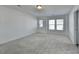 Spacious bedroom with grey carpet, neutral walls, and ample natural light at 1124 Lossie Ln, Grayson, GA 30017