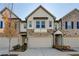 Modern three-story townhome with neutral colors and attached two-car garage at 1124 Lossie Ln, Grayson, GA 30017