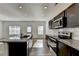 Kitchen boasts granite countertops, stainless steel appliances, and dark cabinetry at 1124 Lossie Ln, Grayson, GA 30017