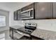 Modern kitchen features granite countertops and stainless steel appliances at 1124 Lossie Ln, Grayson, GA 30017