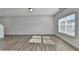 Open living room with wood-look floors and large windows offering natural light at 1124 Lossie Ln, Grayson, GA 30017