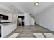 Open living area with hardwood floors and a staircase leading upstairs at 1124 Lossie Ln, Grayson, GA 30017