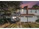 Evening view of tan siding townhouse exterior with walkway and landscaping at 3273 Tennington Pl, Lawrenceville, GA 30044