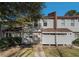 Tan siding townhouse exterior with walkway, landscaping, and street view at 3273 Tennington Pl, Lawrenceville, GA 30044