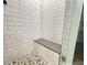 Spa-like shower with built-in seat and pebble floor at 85 Hammock Dr, Covington, GA 30016