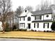 Two-story house with white exterior, black shutters, and a manicured lawn at 1563 Bailey Farms Dr, Lawrenceville, GA 30043