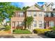 Brick and beige townhome with landscaping, steps, and parking at 1343 Penhurst Dr, Lawrenceville, GA 30043