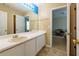 Bathroom with single sink vanity, blue accent wall, and tiled floor at 4701 Highpoint Ln, Atlanta, GA 30349