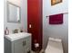 Small bathroom with gray vanity and red accent wall at 4701 Highpoint Ln, Atlanta, GA 30349