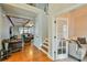 Bright entryway with hardwood floors, a staircase, and French doors leading to a den at 5997 Wild Creek Rd, Sugar Hill, GA 30518