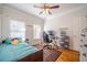 Cozy bedroom with hardwood floors and a ceiling fan at 1300 Tribble Walk Ct, Lawrenceville, GA 30045