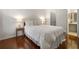 Bedroom with hardwood floors, a queen bed, and access to a bathroom at 1362 Branch Dr, Tucker, GA 30084