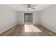 Bright bedroom with wood-look floors and access to balcony at 306 River Mill Cir, Roswell, GA 30075