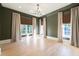 Empty bedroom with hardwood floors, large windows, and olive green walls at 3205 Verdun Nw Dr, Atlanta, GA 30305