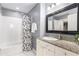 Updated bathroom with granite countertop, white cabinets, and subway tile at 565 Peachtree Ne St # 1209, Atlanta, GA 30308