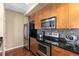 Modern kitchen with stainless steel appliances and granite countertops at 565 Peachtree Ne St # 1209, Atlanta, GA 30308