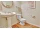 Clean powder room with pedestal sink and hardwood floor at 116 Centennial Dr, Peachtree City, GA 30269