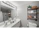 Bathroom with double vanity and stylish shelving at 1189 Liberty Nw Pkwy, Atlanta, GA 30318