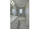 Modern bathroom with marble-style tile and an updated vanity at 541 Sunset Nw Ave, Atlanta, GA 30318