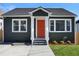 Charming craftsman bungalow with gray siding, white trim, and a bright orange door at 541 Sunset Nw Ave, Atlanta, GA 30318