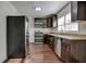 Modern kitchen with dark cabinets, granite countertops, and stainless steel appliances at 541 Sunset Nw Ave, Atlanta, GA 30318