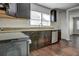 Updated kitchen with granite countertops, dark cabinetry, and modern appliances at 541 Sunset Nw Ave, Atlanta, GA 30318