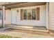 Front entrance with a covered porch and shutters at 5267 Tasman Trl, Lithonia, GA 30038