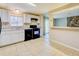 White kitchen with black appliances and view to the living room at 5267 Tasman Trl, Lithonia, GA 30038