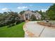 Stately brick home with white columns, lush landscaping, and a circular driveway with a fountain at 2225 Johnson Ferry Rd, Marietta, GA 30062