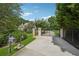 Gated driveway with a mailbox and lush landscaping, leading to a grand estate at 2225 Johnson Ferry Rd, Marietta, GA 30062