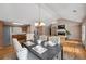 Bright dining room with hardwood floors and modern chandelier adjacent to living room and kitchen at 150 Charleston Pkwy, Dallas, GA 30157