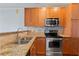 Modern kitchen with wood cabinets and granite counters at 221 Semel Nw Cir # 264, Atlanta, GA 30309