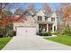 Charming two-story home with brick exterior, covered porch, and attached two-car garage at 3670 Falling Leaf Ln, Cumming, GA 30041