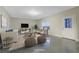 Virtually staged living room with neutral decor and ample natural light at 3670 Falling Leaf Ln, Cumming, GA 30041