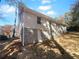 Side view of the house showcasing the stone foundation and white brick exterior at 2320 Capehart Ne Cir, Atlanta, GA 30345