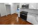 Modern kitchen with white cabinets, granite countertops, and stainless steel appliances at 2320 Capehart Ne Cir, Atlanta, GA 30345