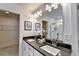 Double vanity bathroom with dark countertop and large mirror at 1597 Aiden Way # 47, Conyers, GA 30013