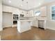 Modern kitchen with white cabinets, an island, and stainless steel appliances at 4004 Glendianne Way, Powder Springs, GA 30127