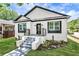 Stunning craftsman style home with white brick exterior, gray steps and modern black accents at 1510 Olympian Sw Way, Atlanta, GA 30310