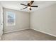 Well-lit bedroom with window, ceiling fan, and carpet at 2311 Carrington Dr, Ellenwood, GA 30294