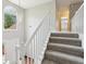 Elegant staircase with white railings and carpeted steps at 2311 Carrington Dr, Ellenwood, GA 30294