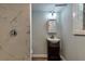 Basement bathroom with modern vanity, shower, and marble tile at 263 Whitworth Drs, Atlanta, GA 30331